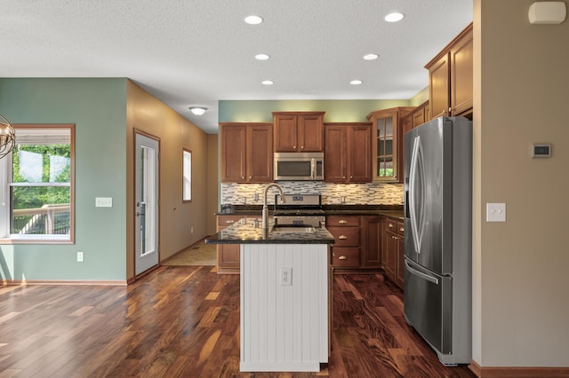 4231 Maple Hurst Dr N, Rockford, MN 55373 - kitchen featuring stainless steel appliances, dark stone countertops, glass insert cabinets, backsplash, and dark wood finished floors