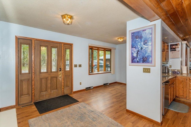 11567 S Lake Blvd, Lake Nebagamon, WI 54849 - entrance foyer featuring light wood-type flooring, baseboards, and a textured ceiling