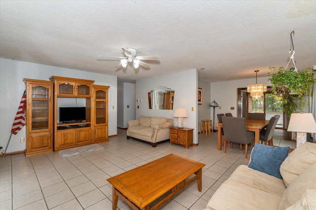 11567 S Lake Blvd, Lake Nebagamon, WI 54849 - living area featuring a chandelier, light tile patterned flooring, ceiling fan, and a textured ceiling
