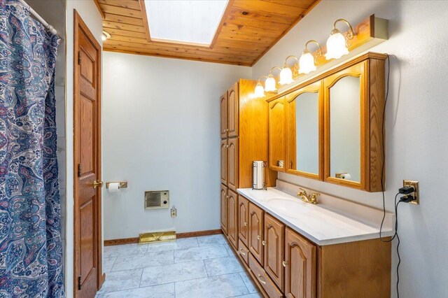 11567 S Lake Blvd, Lake Nebagamon, WI 54849 - bathroom with vanity, wooden ceiling, heating unit, baseboards, and a skylight