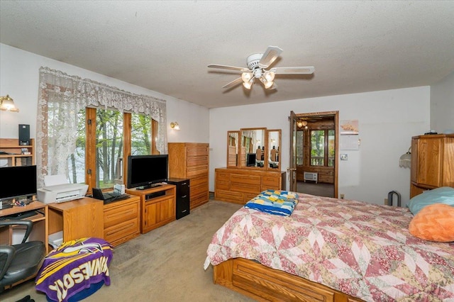 11567 S Lake Blvd, Lake Nebagamon, WI 54849 - bedroom featuring light carpet, an office area, a textured ceiling, and a ceiling fan