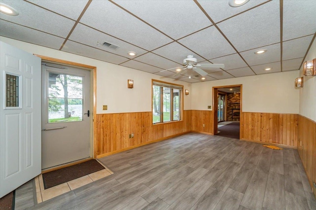 11567 S Lake Blvd, Lake Nebagamon, WI 54849 - foyer entrance with wainscoting, wood walls, wood finished floors, a drop ceiling, and a ceiling fan