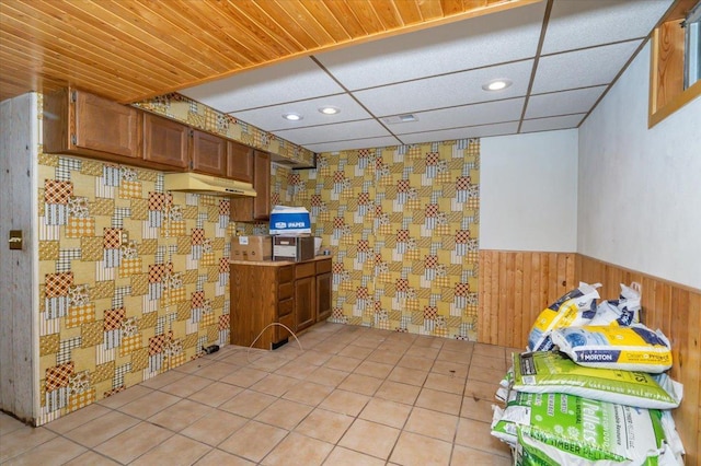 11567 S Lake Blvd, Lake Nebagamon, WI 54849 - kitchen with wainscoting, brown cabinetry, wood walls, recessed lighting, and under cabinet range hood