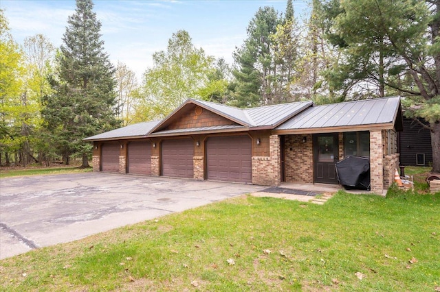 11567 S Lake Blvd, Lake Nebagamon, WI 54849 - ranch-style house with a front yard, asphalt driveway, an attached garage, metal roof, and brick siding