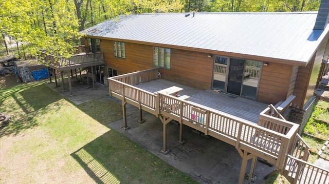 11567 S Lake Blvd, Lake Nebagamon, WI 54849 - back of house with a wooden deck, a lawn, and metal roof