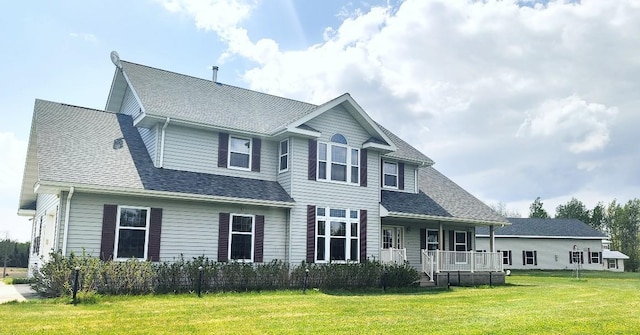 8848 Leander Rd, Angora Twp, MN 55723 - back of house with covered porch, a lawn, and a shingled roof