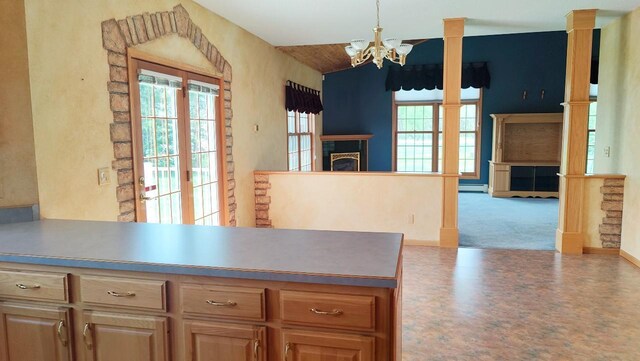 8848 Leander Rd, Angora Twp, MN 55723 - kitchen with a chandelier, a fireplace, a baseboard radiator, and carpet flooring