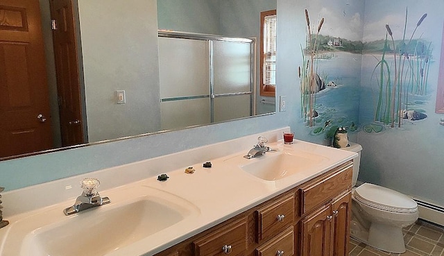 8848 Leander Rd, Angora Twp, MN 55723 - bathroom featuring toilet, a shower with shower door, double vanity, and baseboard heating