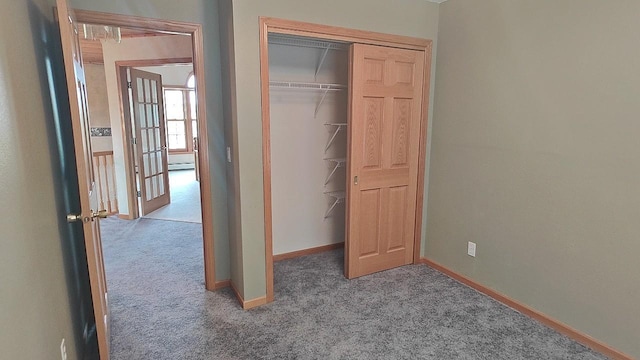 8848 Leander Rd, Angora Twp, MN 55723 - unfurnished bedroom with carpet floors, baseboards, a closet, and a baseboard radiator