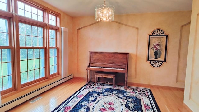 8848 Leander Rd, Angora Twp, MN 55723 - sitting room with a baseboard heating unit, wood finished floors, and a chandelier