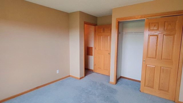 8848 Leander Rd, Angora Twp, MN 55723 - unfurnished bedroom with carpet flooring, baseboards, and a closet