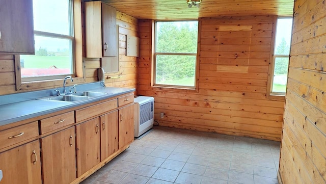 8848 Leander Rd, Angora Twp, MN 55723 - kitchen with a sink, wooden ceiling, light countertops, wood walls, and plenty of natural light
