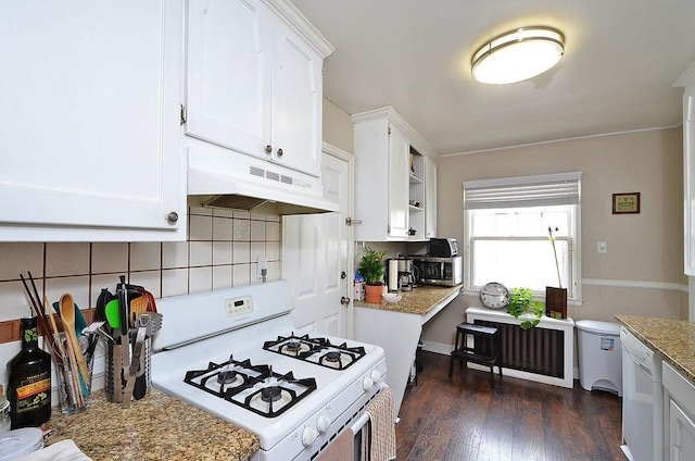 4429 Portland Ave, Minneapolis, MN 55407 - kitchen featuring white appliances, under cabinet range hood, white cabinets, dark wood-style floors, and tasteful backsplash