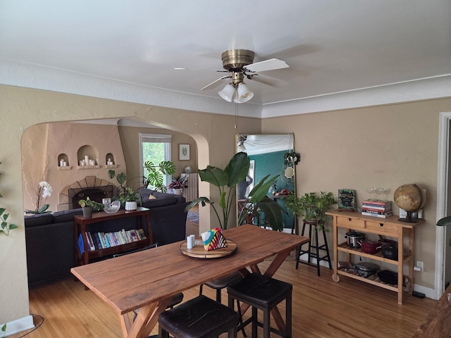 4429 Portland Ave, Minneapolis, MN 55407 - dining room featuring ceiling fan, wood finished floors, and arched walkways