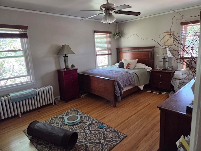 4429 Portland Ave, Minneapolis, MN 55407 - bedroom with radiator heating unit, ornamental molding, light wood finished floors, and ceiling fan