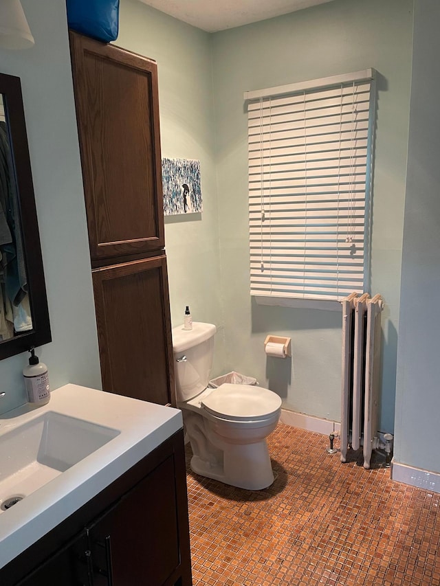 4429 Portland Ave, Minneapolis, MN 55407 - bathroom featuring radiator heating unit, toilet, vanity, and baseboards