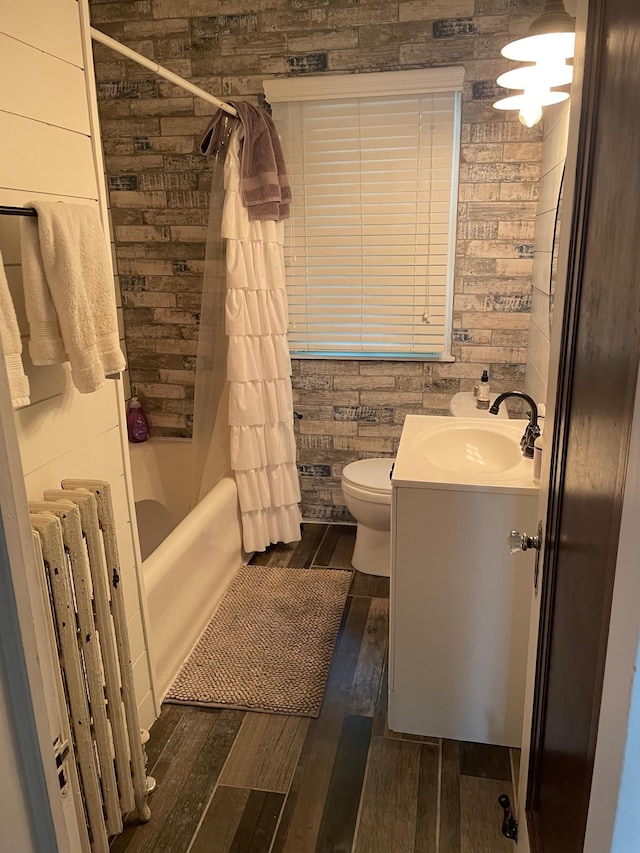 4429 Portland Ave, Minneapolis, MN 55407 - full bathroom with radiator, hardwood / wood-style flooring, toilet, vanity, and shower / bathtub combination with curtain