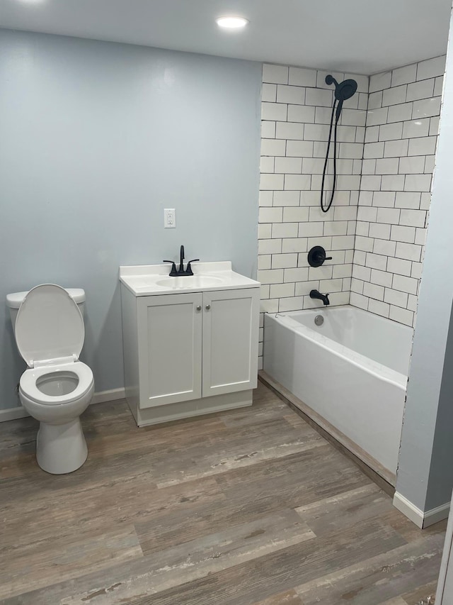 4429 Portland Ave, Minneapolis, MN 55407 - full bath featuring toilet, shower / bathtub combination, vanity, wood finished floors, and baseboards