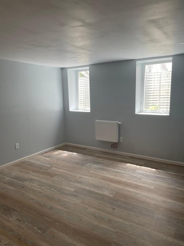 4429 Portland Ave, Minneapolis, MN 55407 - empty room featuring radiator heating unit, wood finished floors, and baseboards