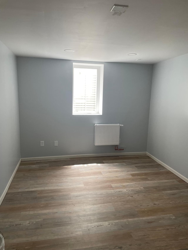 4429 Portland Ave, Minneapolis, MN 55407 - spare room with radiator, wood finished floors, and baseboards
