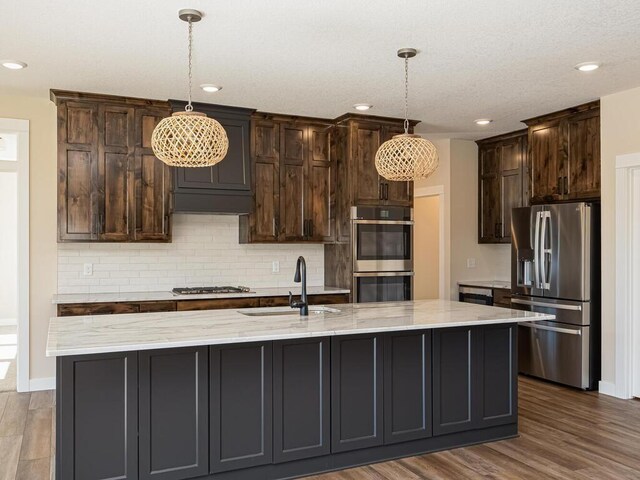 20666 Tamarack St NW, Oak Grove, MN 55011 - kitchen featuring appliances with stainless steel finishes, a sink, backsplash, recessed lighting, and decorative light fixtures