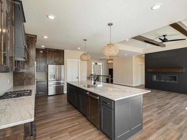 20666 Tamarack St NW, Oak Grove, MN 55011 - kitchen with stainless steel appliances, ceiling fan, open floor plan, a sink, and light wood-type flooring