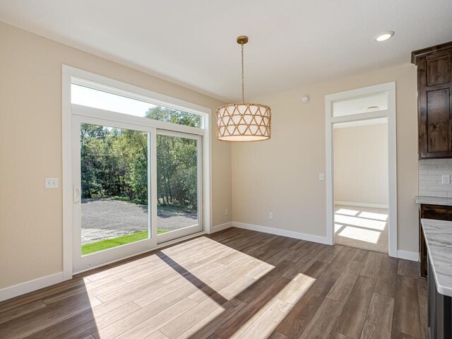20666 Tamarack St NW, Oak Grove, MN 55011 - unfurnished dining area with dark wood-style flooring, baseboards, and recessed lighting