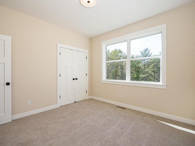 20666 Tamarack St NW, Oak Grove, MN 55011 - unfurnished bedroom featuring light carpet, baseboards, and a closet