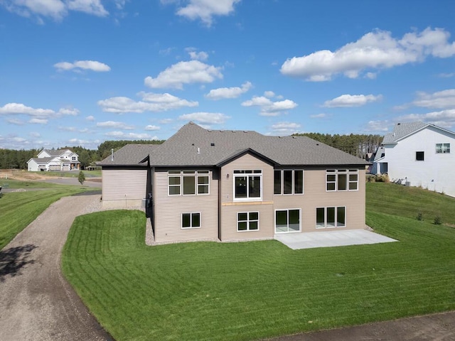 20666 Tamarack St NW, Oak Grove, MN 55011 - rear view of property with a patio area, a lawn, and a shingled roof