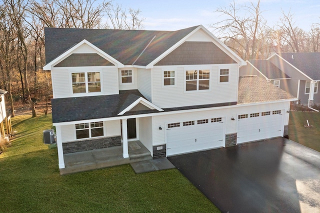 1708 Misty Cir, Buffalo, MN 55313 - view of front of home with driveway, stone siding, central AC unit, a front lawn, and a shingled roof