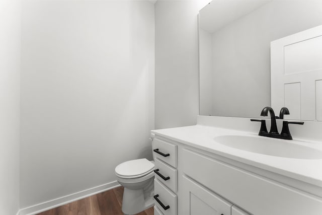 1708 Misty Cir, Buffalo, MN 55313 - half bathroom with wood finished floors, vanity, toilet, and baseboards