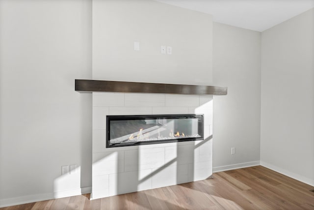 1708 Misty Cir, Buffalo, MN 55313 - detailed view of a tile fireplace, wood finished floors, and baseboards