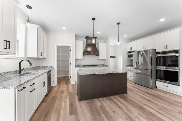 1708 Misty Cir, Buffalo, MN 55313 - kitchen featuring stainless steel appliances, custom range hood, a sink, light wood-style flooring, and a center island