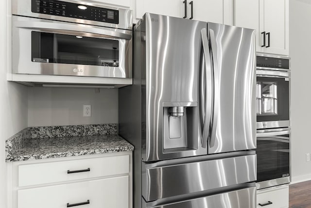 1708 Misty Cir, Buffalo, MN 55313 - kitchen with appliances with stainless steel finishes, light stone counters, white cabinetry, and dark wood-style floors
