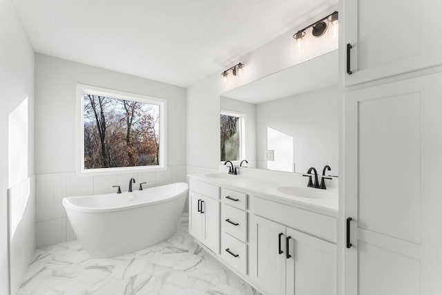 1708 Misty Cir, Buffalo, MN 55313 - bathroom with marble finish flooring, wainscoting, a freestanding tub, and double vanity