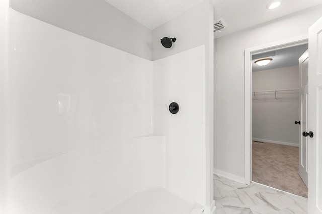 1708 Misty Cir, Buffalo, MN 55313 - full bath featuring a shower, a spacious closet, marble look tiles, and baseboards