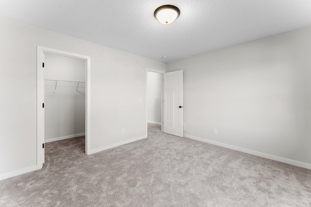1708 Misty Cir, Buffalo, MN 55313 - unfurnished bedroom with carpet, baseboards, a spacious closet, a closet, and a textured ceiling