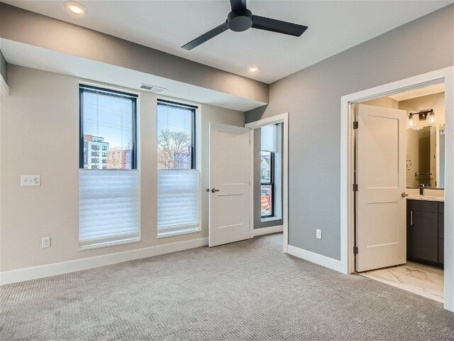 4745 Minnehaha Ave Unit 101, Minneapolis, MN 55406 - unfurnished bedroom with baseboards, a sink, light carpet, recessed lighting, and connected bathroom