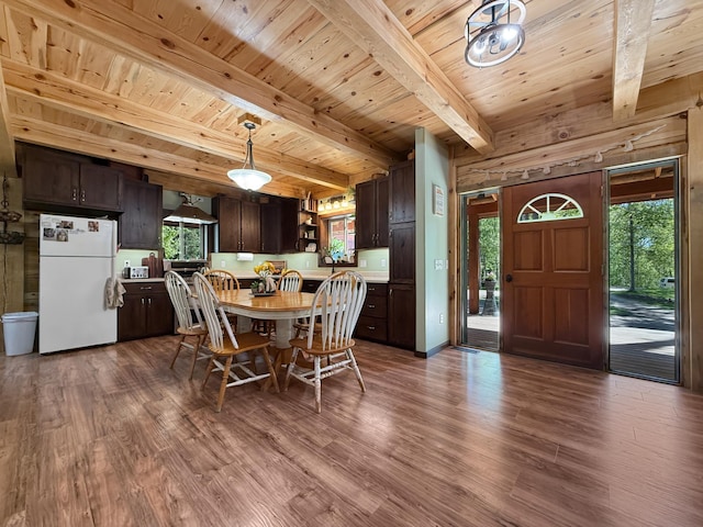 7215 Little Dip Ln NE, Bemidji, MN 56601 - dining space featuring dark wood-type flooring and wooden ceiling with exposed beams