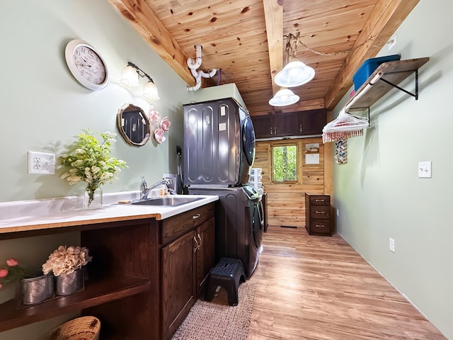 7215 Little Dip Ln NE, Bemidji, MN 56601 - washroom with stacked washer and clothes dryer, a sink, wood ceiling, and light wood-type flooring