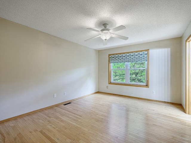 5420 Saxony Ct, White Bear Twp, MN 55110 - empty room with light wood finished floors, a ceiling fan, baseboards, and a textured ceiling