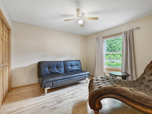 5420 Saxony Ct, White Bear Twp, MN 55110 - sitting room featuring hardwood / wood-style floors, a ceiling fan, baseboards, and a textured ceiling