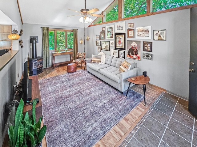 12216 175th St W, Lakeville, MN 55044 - living area with a wood stove, ceiling fan, lofted ceiling, wood finished floors, and baseboards
