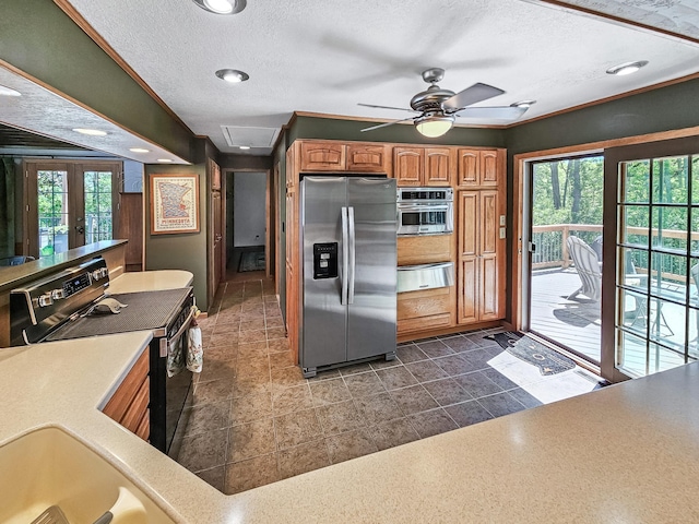 12216 175th St W, Lakeville, MN 55044 - kitchen featuring appliances with stainless steel finishes, brown cabinetry, a warming drawer, light countertops, and a ceiling fan