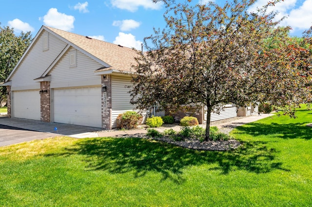 2990 David Cir, Little Canada, MN 55117 - view of front of property with a front lawn, driveway, brick siding, roof with shingles, and an attached garage
