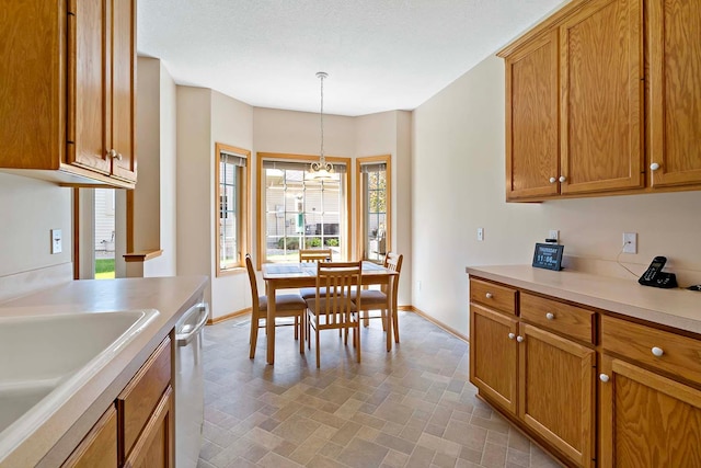 2990 David Cir, Little Canada, MN 55117 - kitchen with baseboards, light countertops, dishwasher, and pendant lighting
