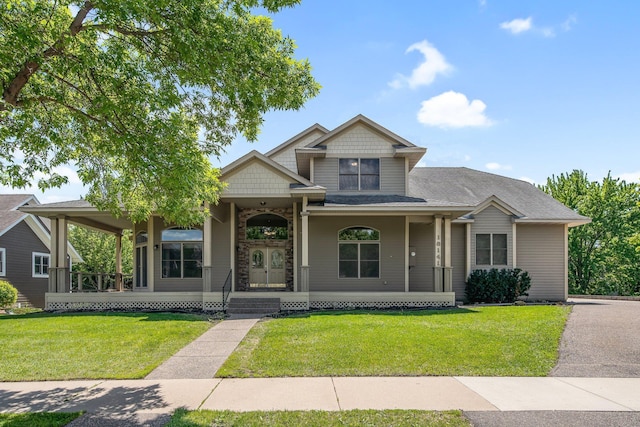 18141 87th Ave N, Maple Grove, MN 55311 - craftsman-style house with a front lawn, a porch, and stone siding