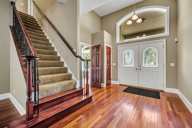 18141 87th Ave N, Maple Grove, MN 55311 - entryway featuring stairway, hardwood / wood-style floors, baseboards, and a towering ceiling
