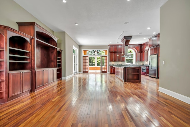 18141 87th Ave N, Maple Grove, MN 55311 - kitchen featuring stainless steel fridge with ice dispenser, open shelves, dark brown cabinets, baseboards, and light wood-style flooring