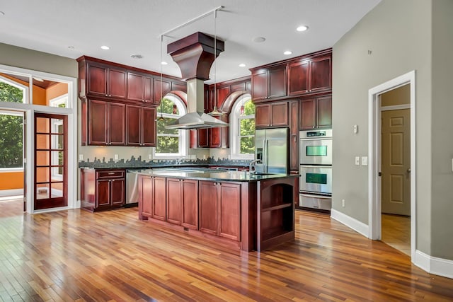 18141 87th Ave N, Maple Grove, MN 55311 - kitchen with dark brown cabinets, stainless steel appliances, dark countertops, a warming drawer, and recessed lighting